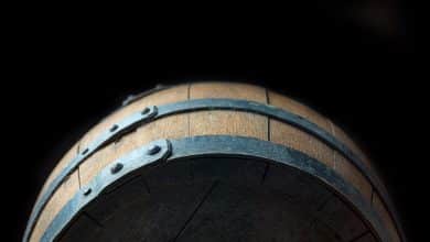 old wooden barrel on black background